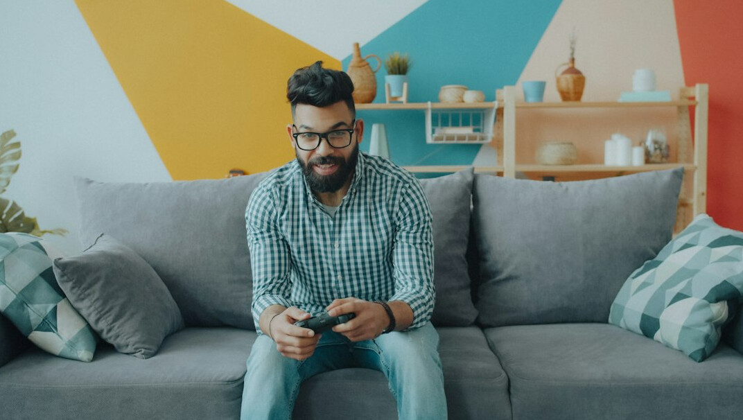 Uruguayan man in his late fifties with glasses looking over household bills with a cup of mate