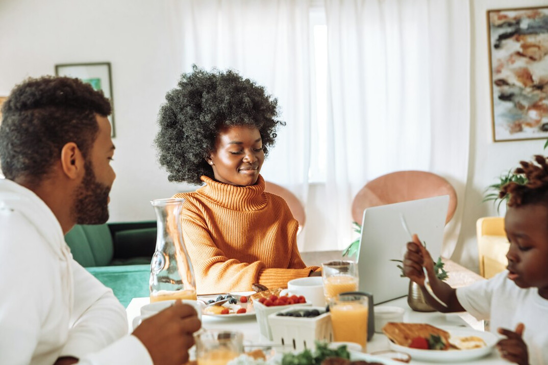 family sitting at table with budget papers