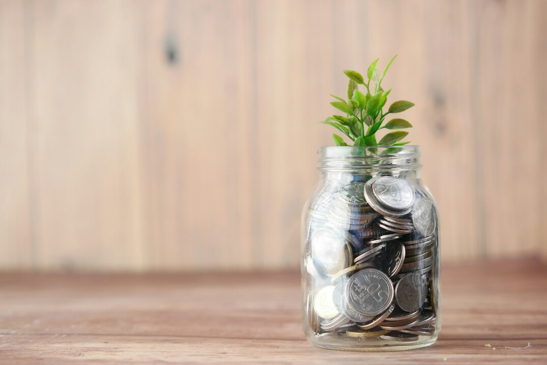 child saving money in jar